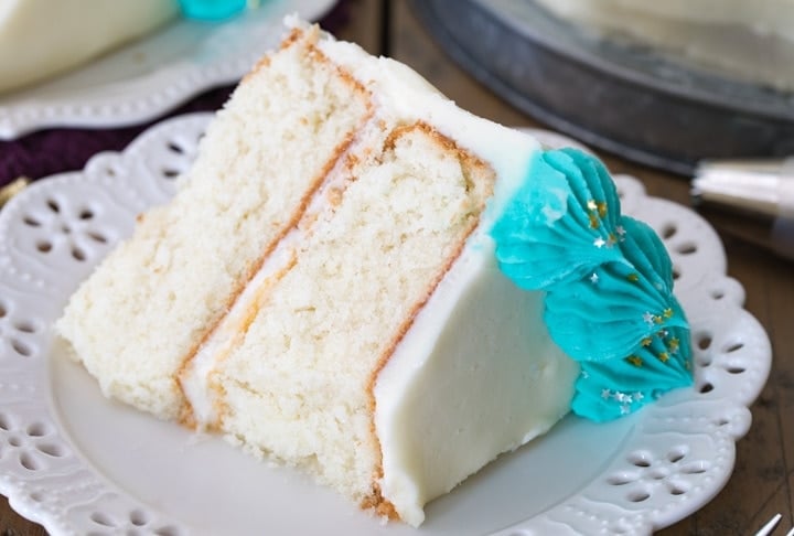 Slice of white cake on a white plate