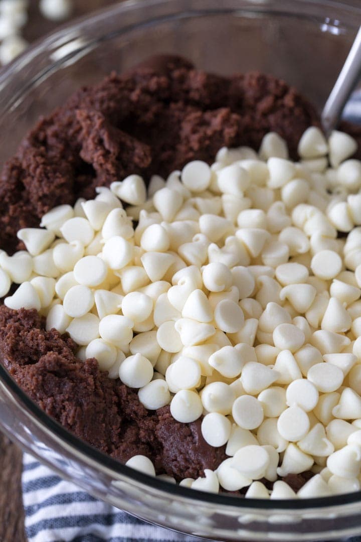 Bowl of chocolate cookie dough with white chocolate chips.