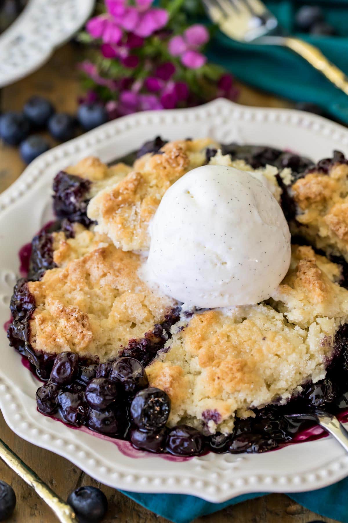 blueberry cobbler on white plate with ice cream