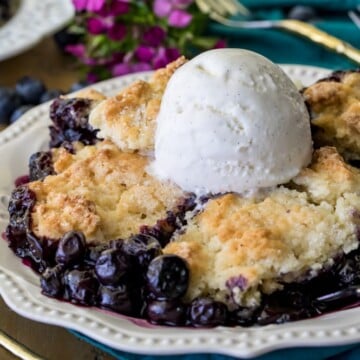 Plated blueberry cobbler with scoop of vanilla ice cream