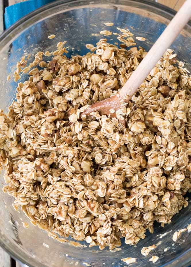 Granola bar batter in glass mixing bowl