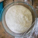 Pizza dough in glass bowl, after rising