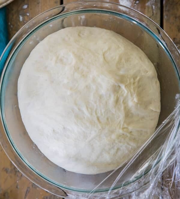 Pizza dough in glass bowl, after rising