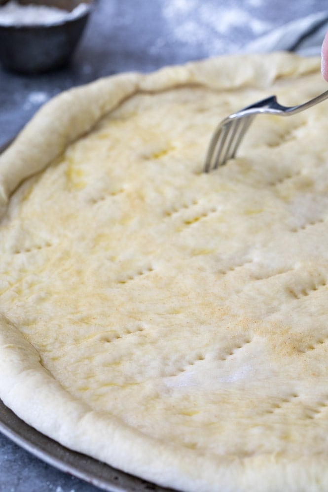 Pizza dough on pizza pan