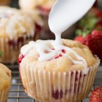 Drizzling glaze on a strawberry muffin