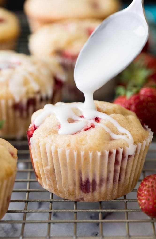 Drizzling glaze on a strawberry muffin