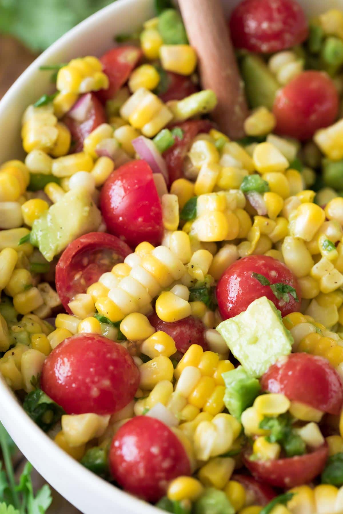 close up of corn salad in white bowl