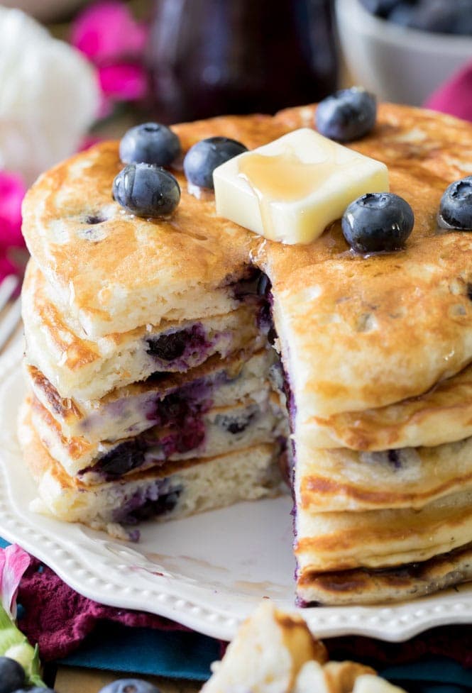 Stack of blueberry pancakes topped with pat of butter