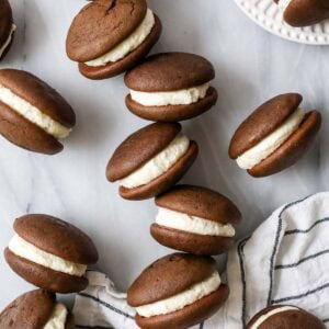Scattered whoopie pies sitting on their sides to show their creamy filling.