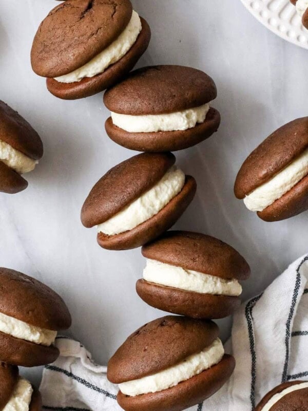 Scattered whoopie pies sitting on their sides to show their creamy filling.