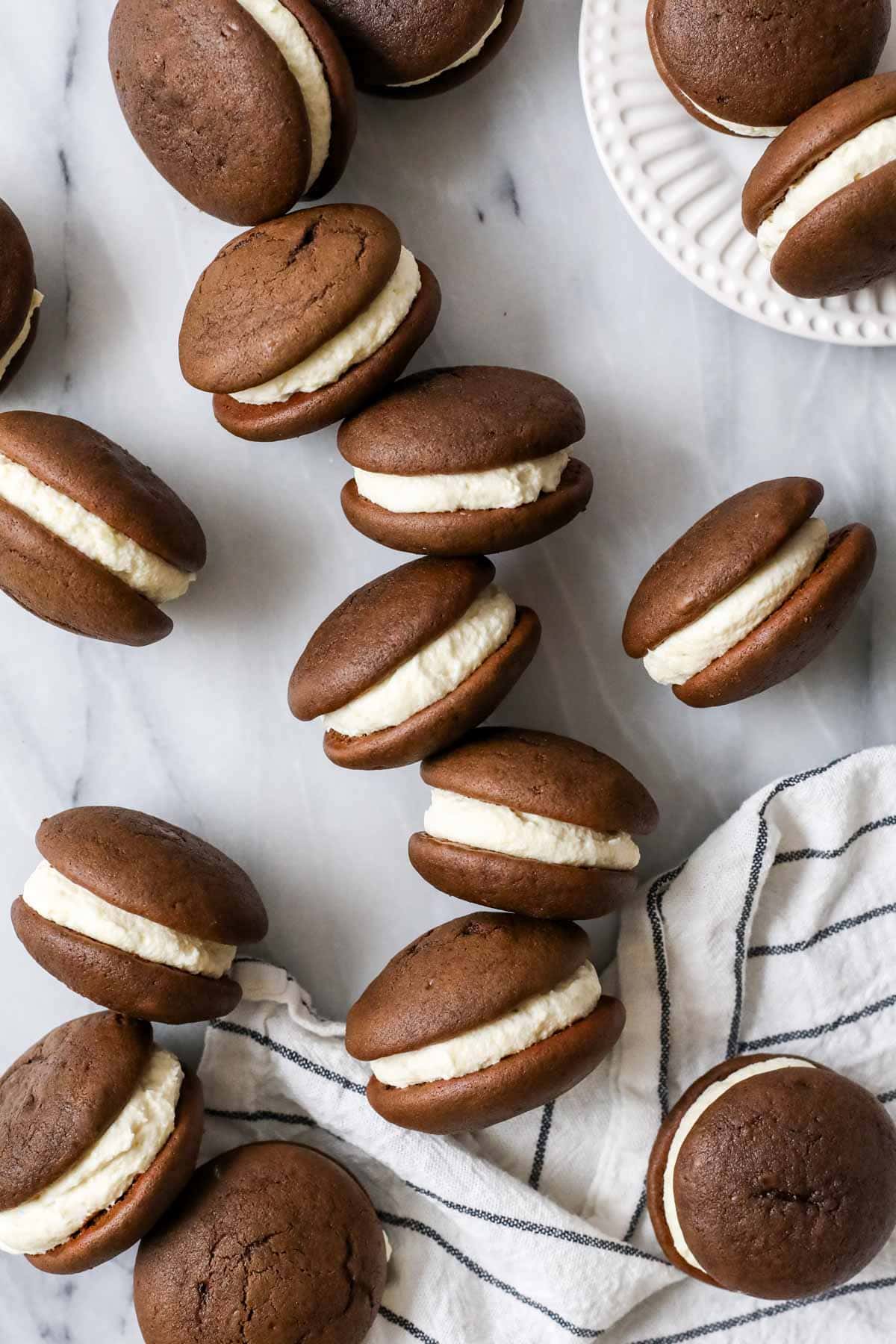 Scattered whoopie pies sitting on their sides to show their creamy filling.