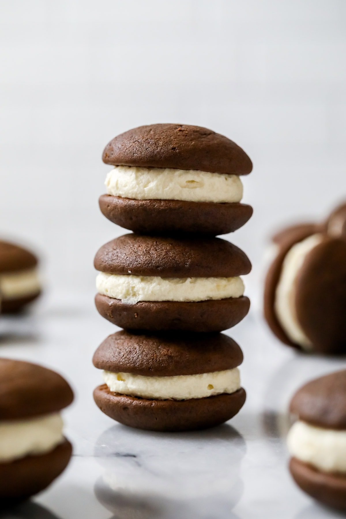 Stack of three chocolate whoopie pies with a creamy vanilla filling.