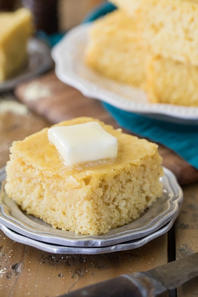 A piece of buttermilk cornbread with butter melting on top