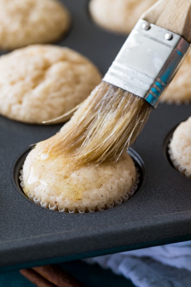 Brushing butter on a warm cinnamon muffin