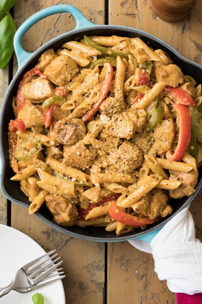 Cajun chicken cooking in skillet