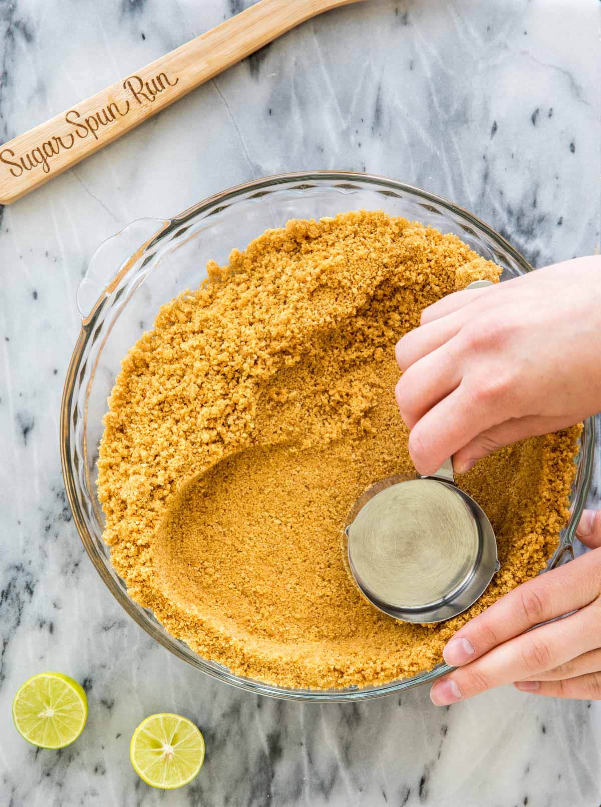 pressing graham cracker crumbs into crust