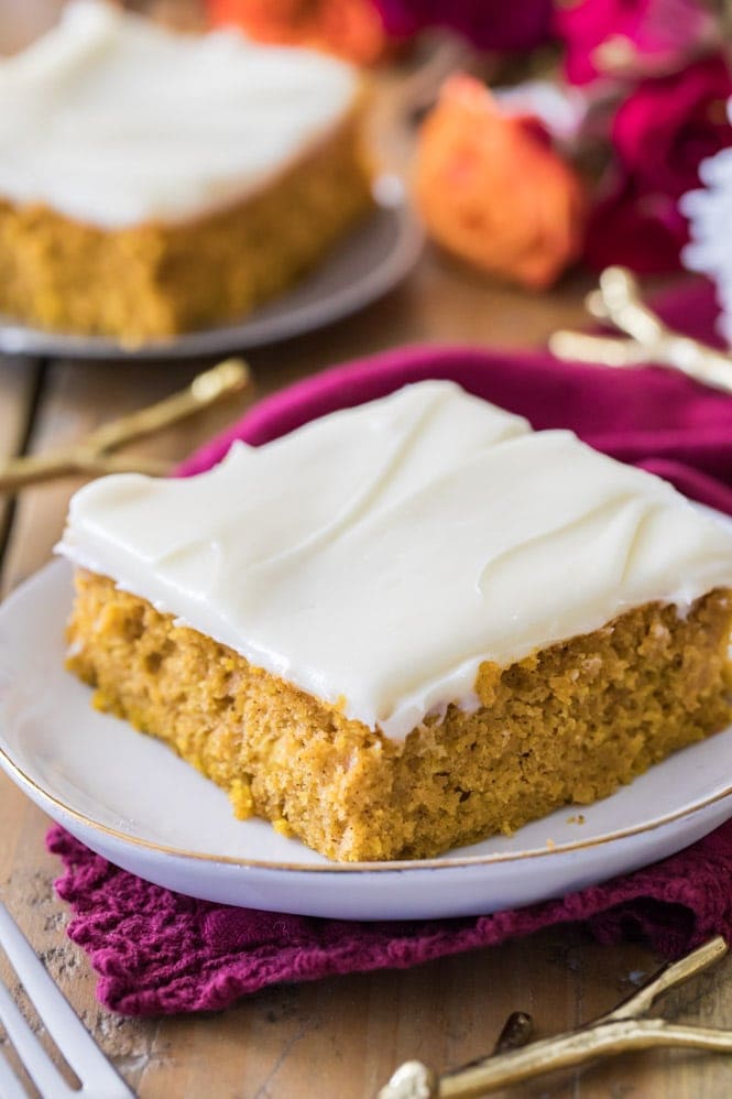 Pumpkin bar with cream cheese frosting on white plate