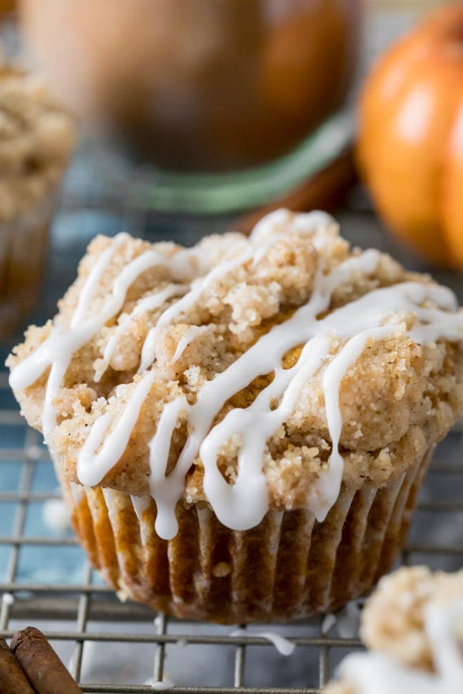 Freshly baked pumpkin muffin with vanilla glaze on cooling rack