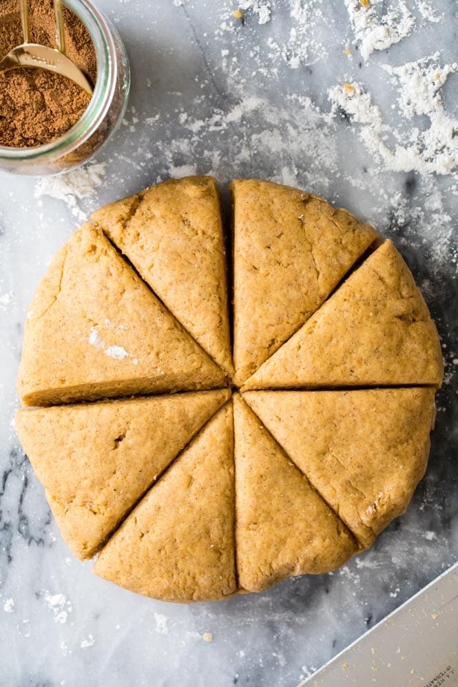 Making pumpkin scones: form the dough into disc and cut into wedges