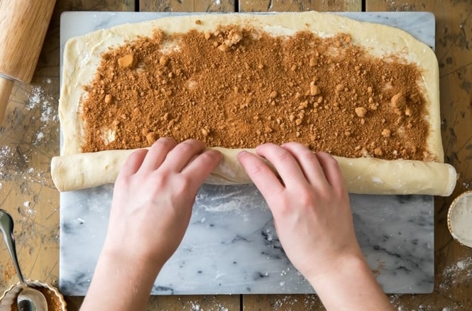 Rolling cinnamon roll dough