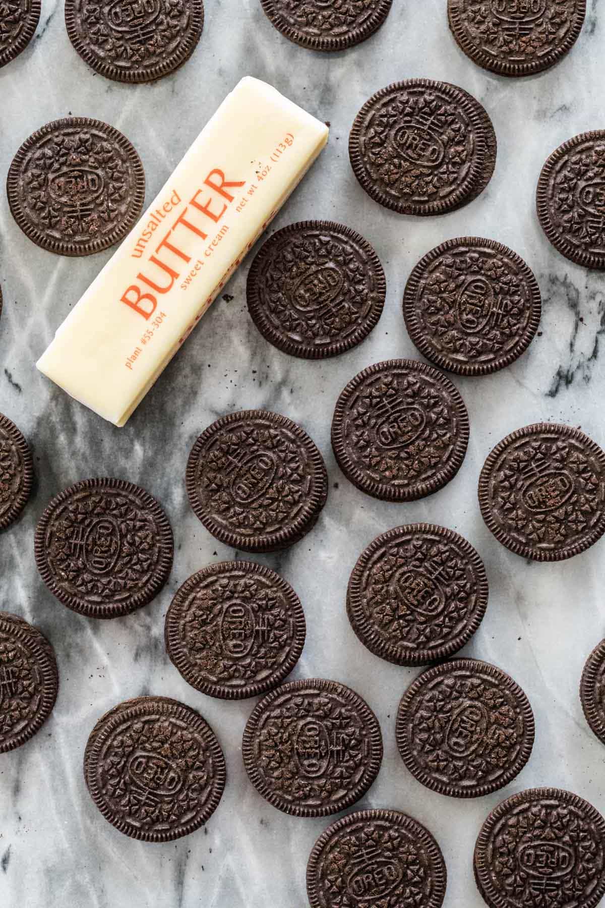 oreo cookies and stick of butter on marble