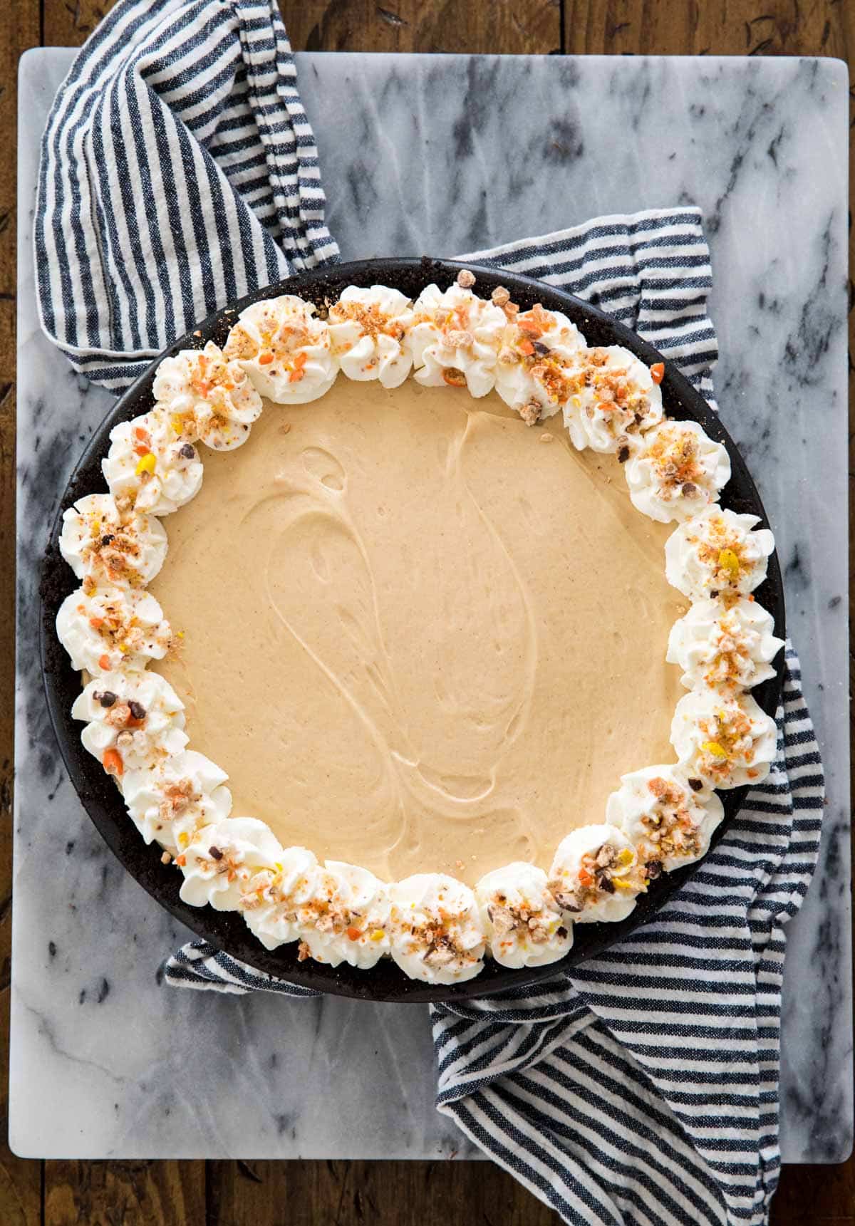 overhead of peanut butter pie with decorative whipped cream topping