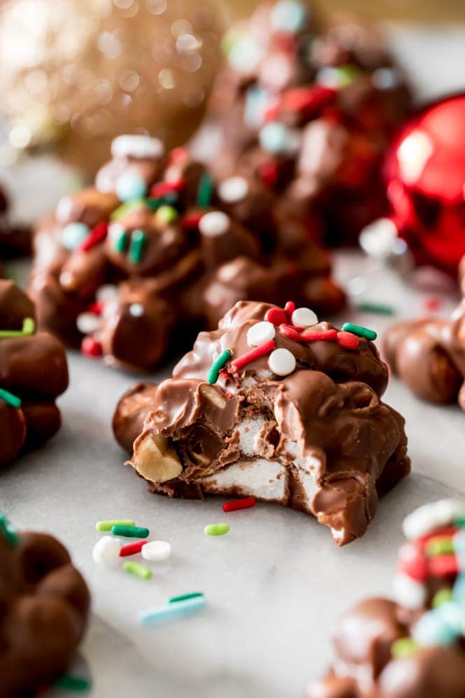 Rocky road peanut cluster with bite out of it -- showing marshmallow and peanut interior