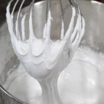Seafoam batter on whisk in mixing bowl