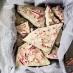 Peppermint Bark pieces in container on marble surface