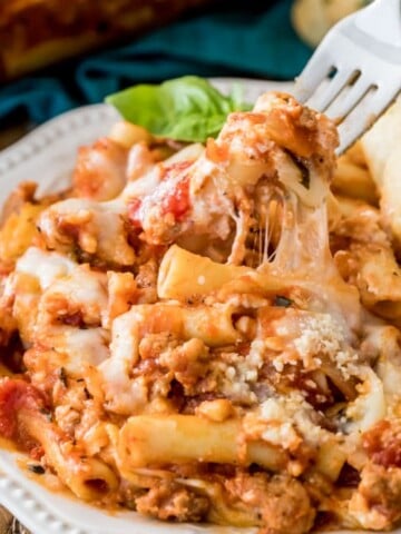 Fork lifting baked ziti off plate