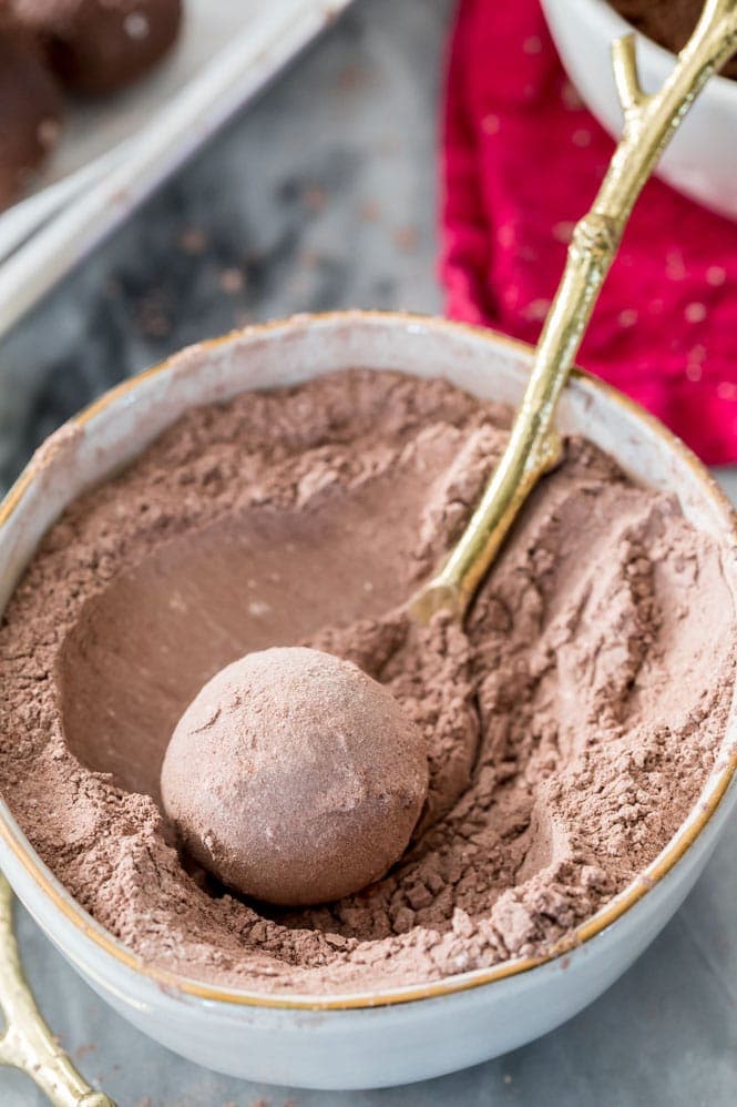 Rolling chocolate truffle in a cocoa sugar powder