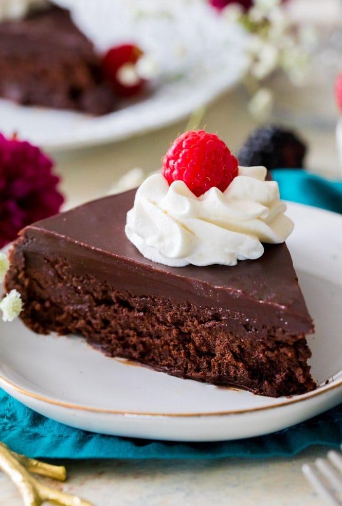 Slice of flourless chocolate cake on white plate