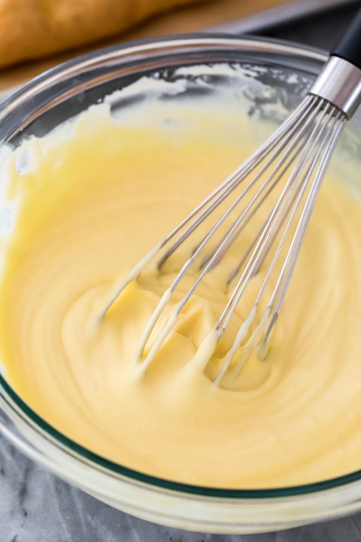 Crème Pâtissière being whisked in a glass bowl