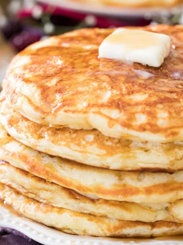 buttermilk pancakes on white plate with butter