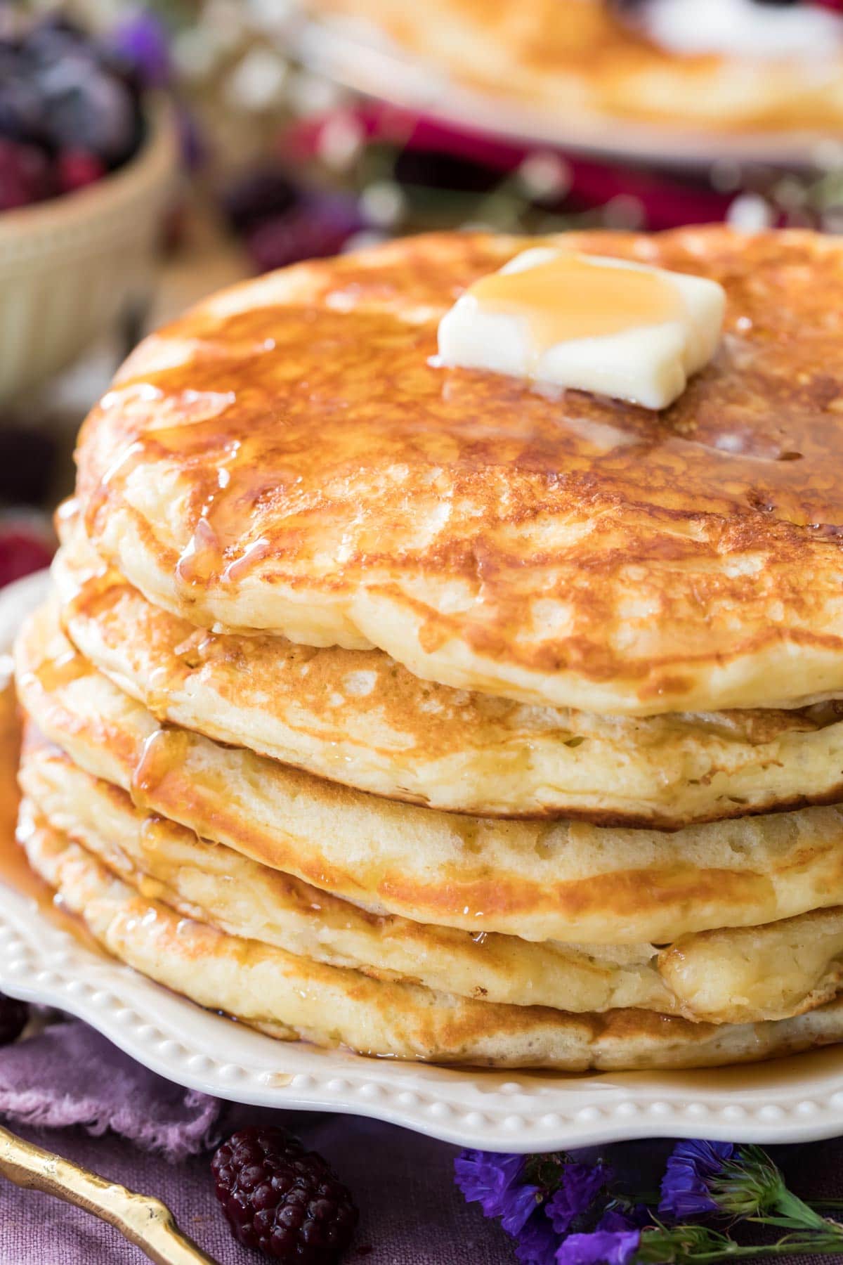 buttermilk pancakes on white plate with butter