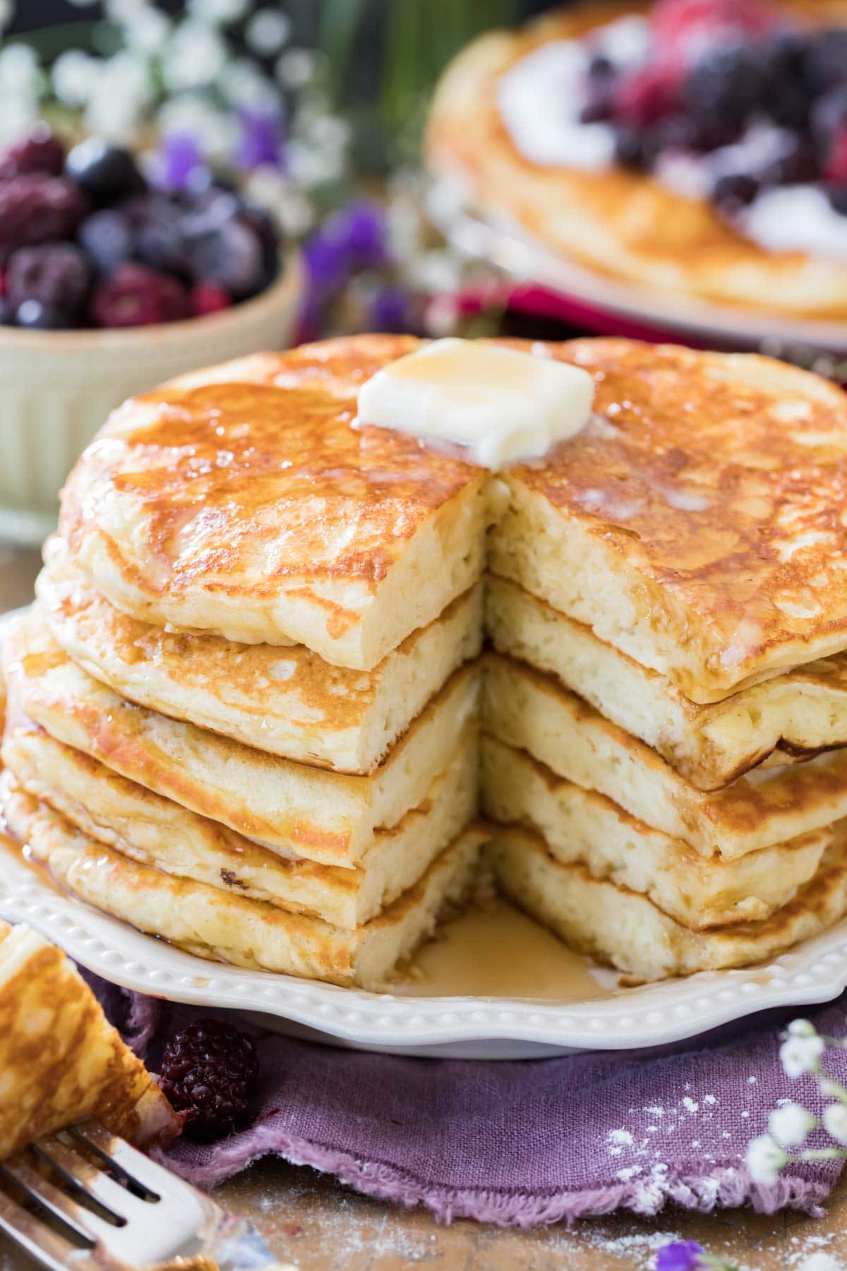 buttermilk pancakes on white plate with butter