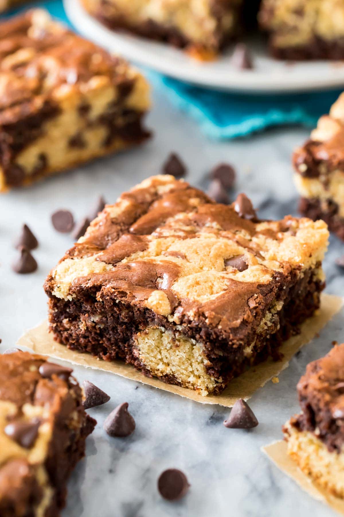 brookie bar on a piece of parchment paper, surrounded by chocolate chips