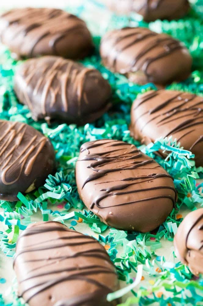 Chocolate covered Peanut Butter Eggs on green Easter grass