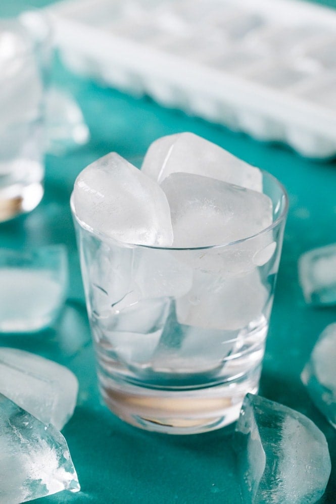 Ice cubes in a clear glass blue background