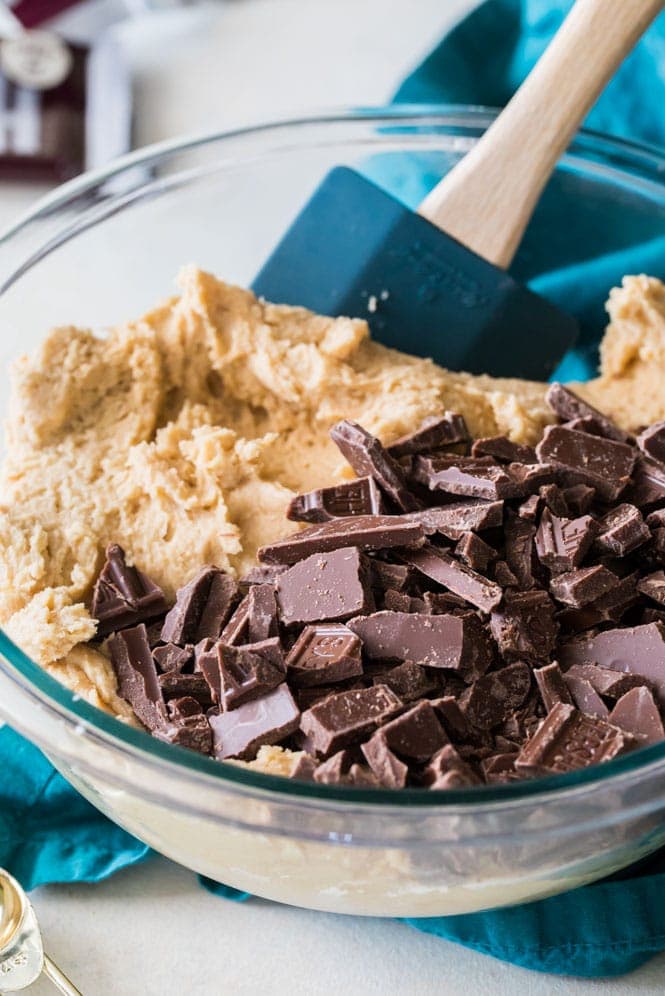 Cookie Dough in bowl - stirring chocolate pieces into peanut butter dough