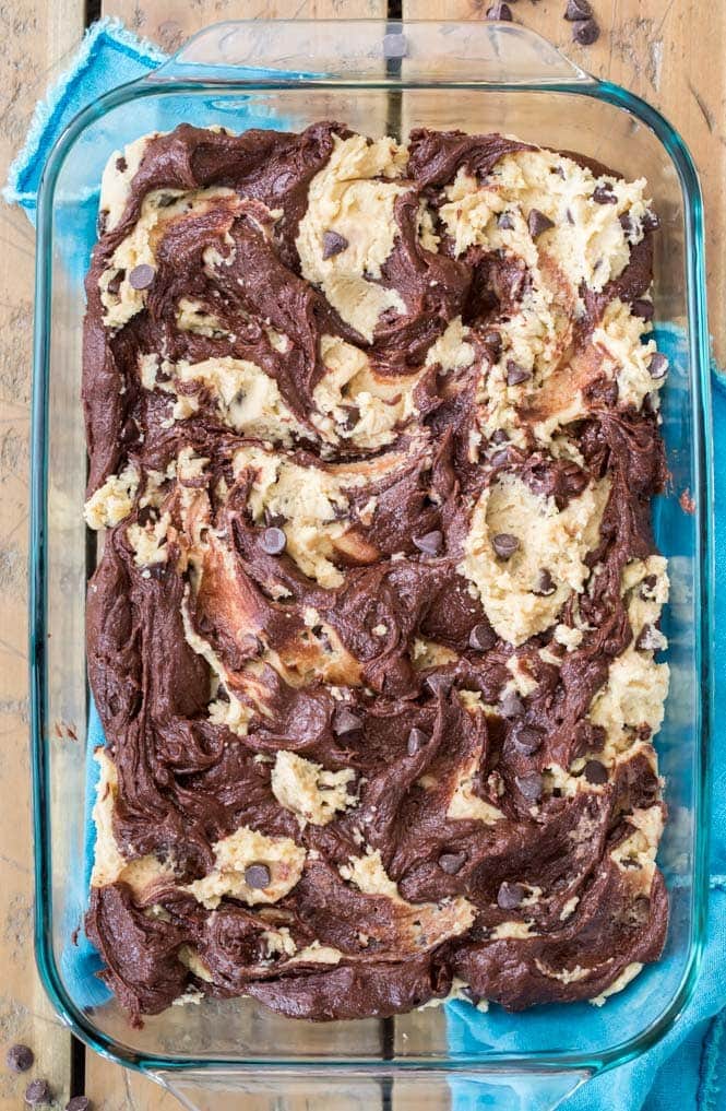 brownie batter and cookie dough swirled together in baking dish to make brookies
