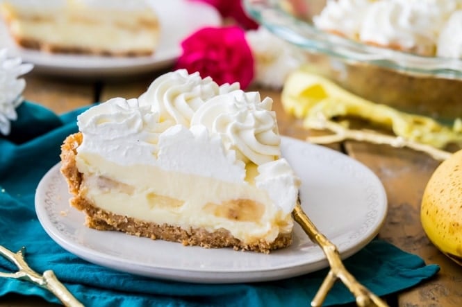 Slice of banana cream pie with whipped cream on plate