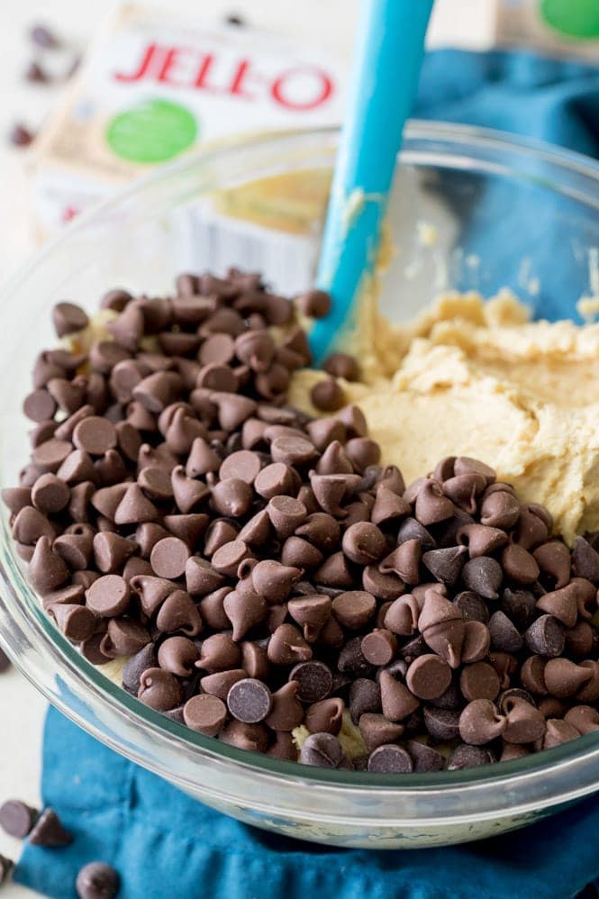 Making pudding cookies -- Stirring chocolate chips into dough