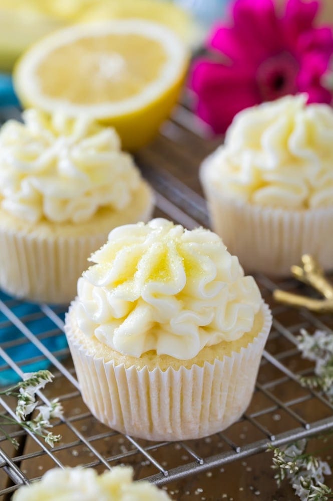 Lemon cupcake with lemon frosting and yellow decorating sugar on cooling rack