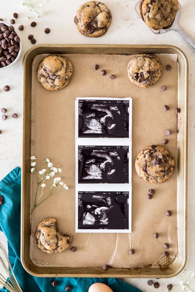 Baby scan photos on cookie sheet with cookies