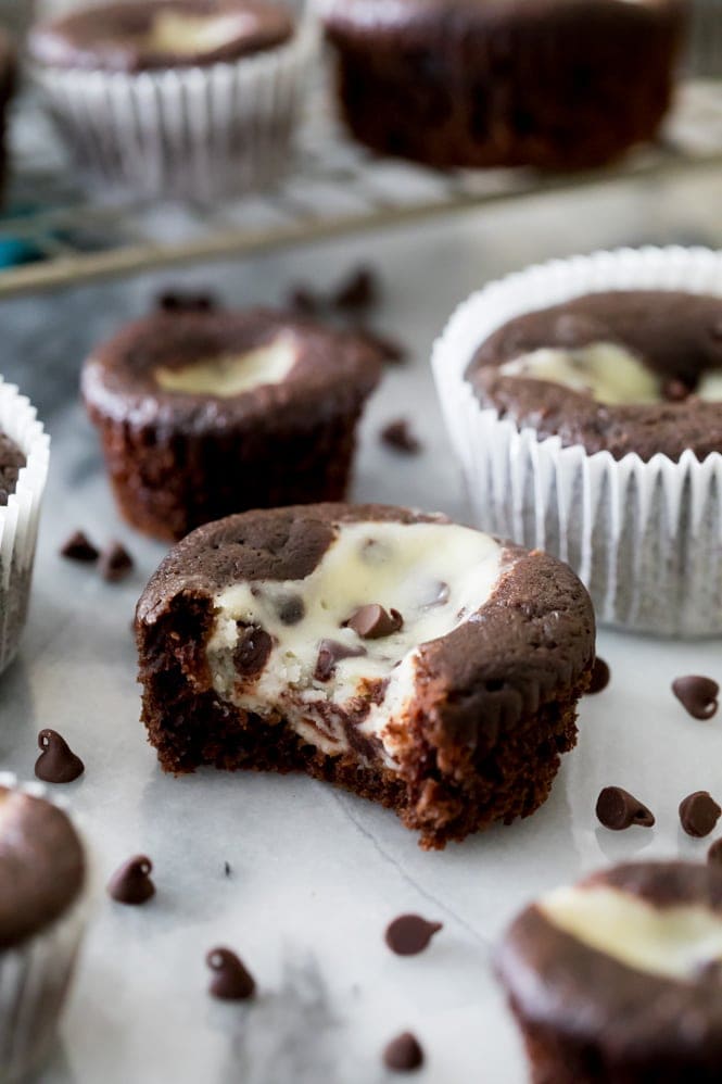 Black bottom cupcake with a bite out of it, showing cheesecake center