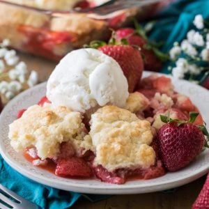 strawberry cobbler with scoop of vanilla icing on a plate