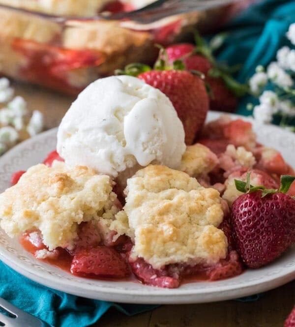 strawberry cobbler with scoop of vanilla icing on a plate