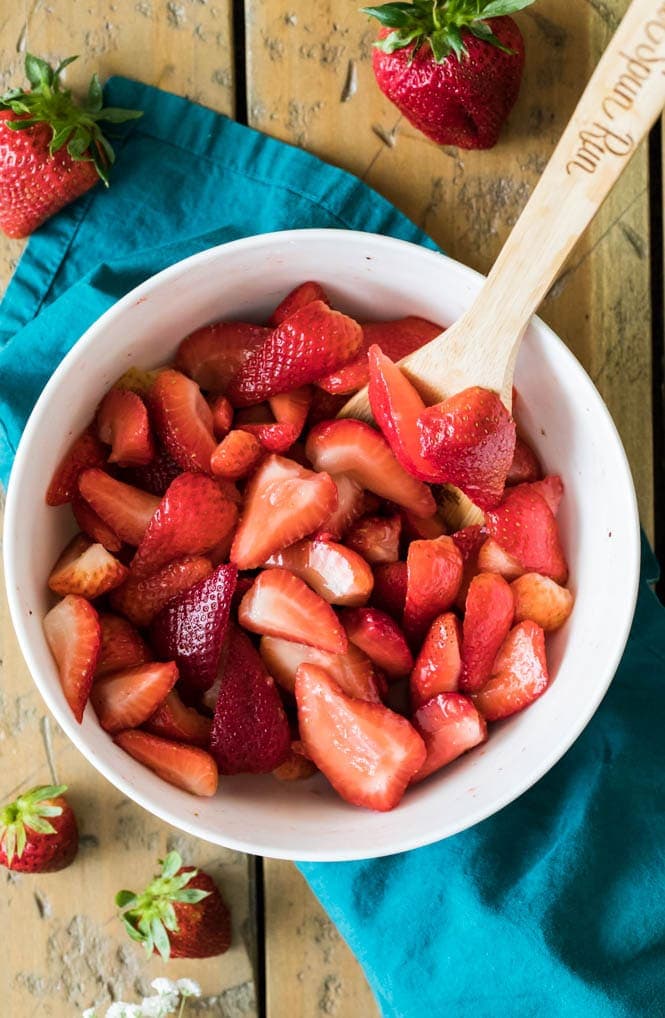 White bowl full of strawberries to make strawberry cobbler