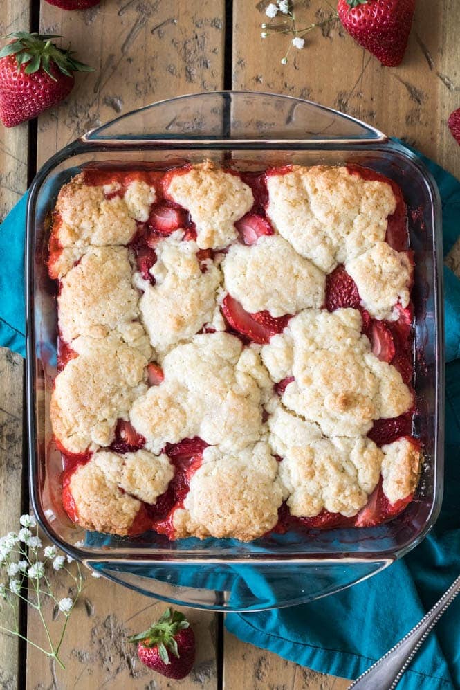 overhead shot of strawberry cobbler in glass square baking dish